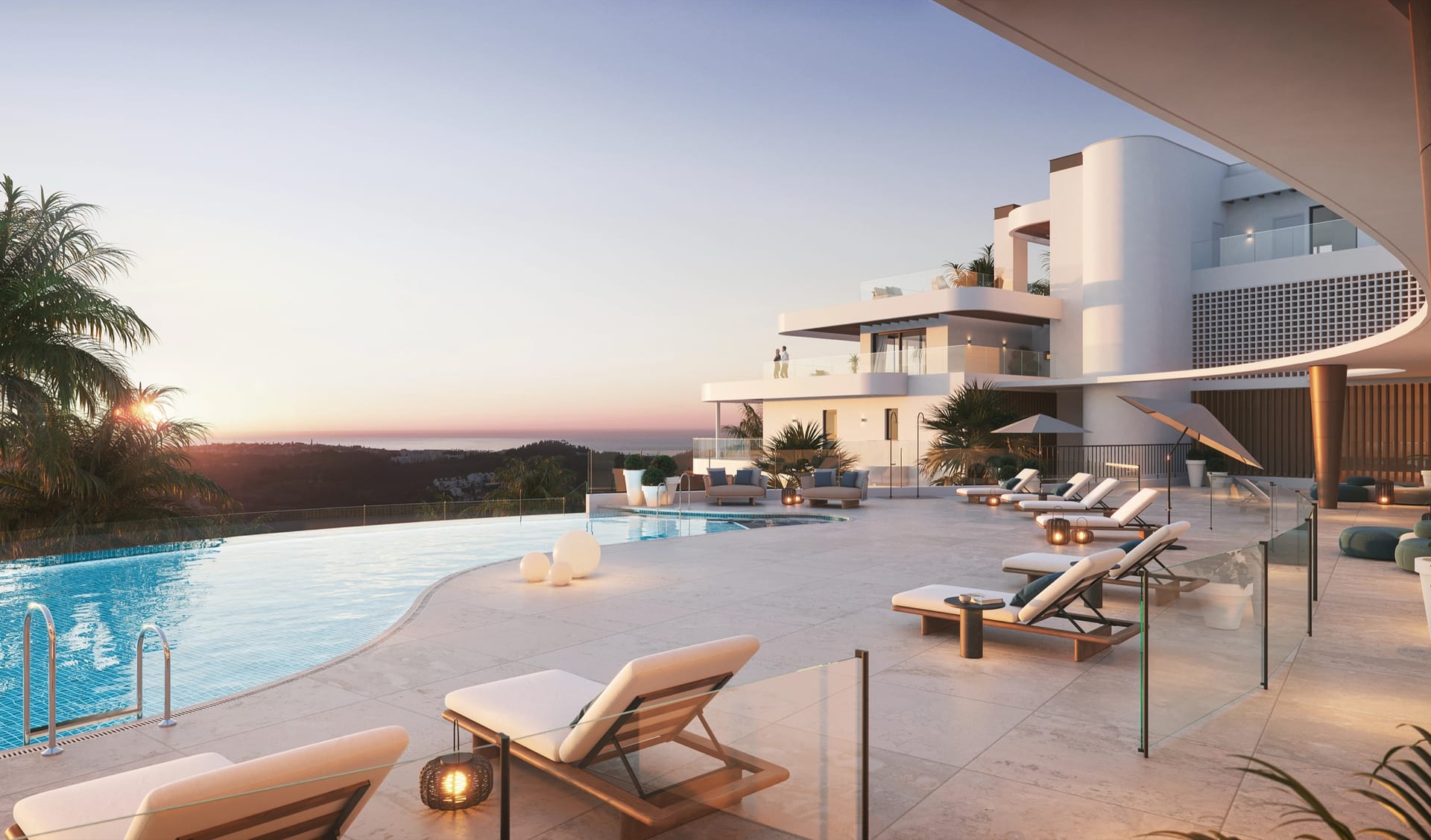 The infinity pool at dusk, with the buildings behind it and the coast beyond. 360º, Cerrado del Águila, Mijas.