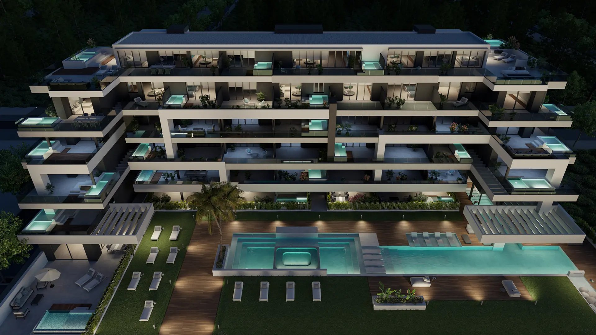 The scheme from the air at night, with the shared pool in front of it and a small pool lit on many of the terraces. Almitak, Parque de las Lagunas, Mijas.
