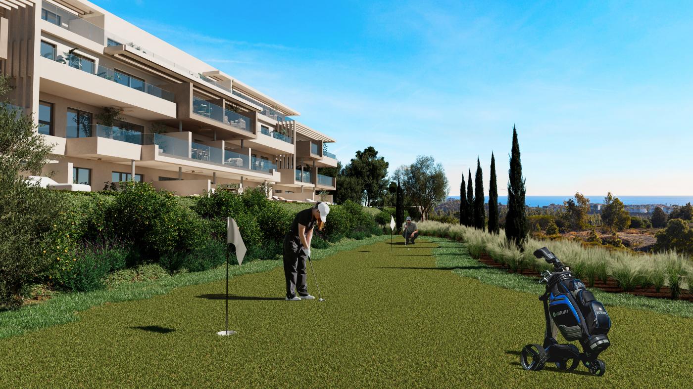 The putting green in the gardens, with the buildings to one side. Altos del Chaparral, El Chaparral, Mijas.