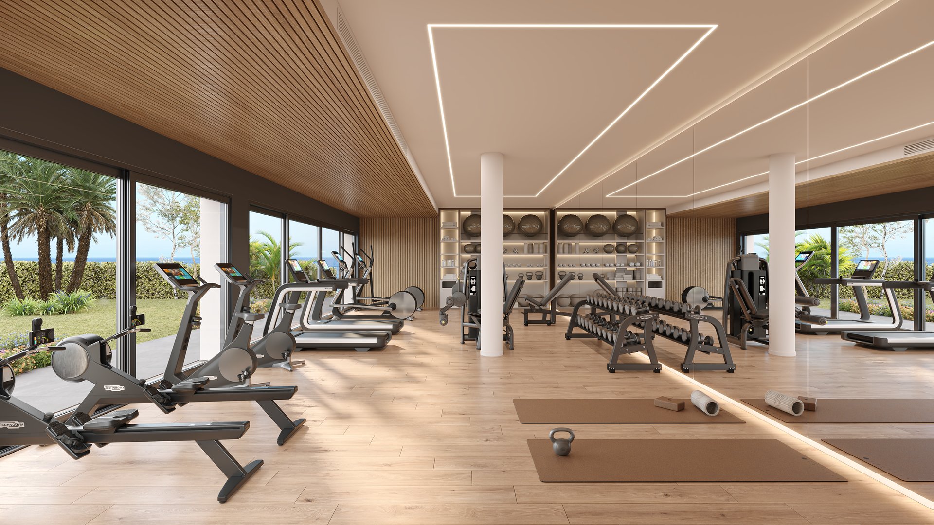 The gym, with running machines and weight benches under a slatted wood ceiling and glazing down one side. Alura Living, Casares Costa, Casares.