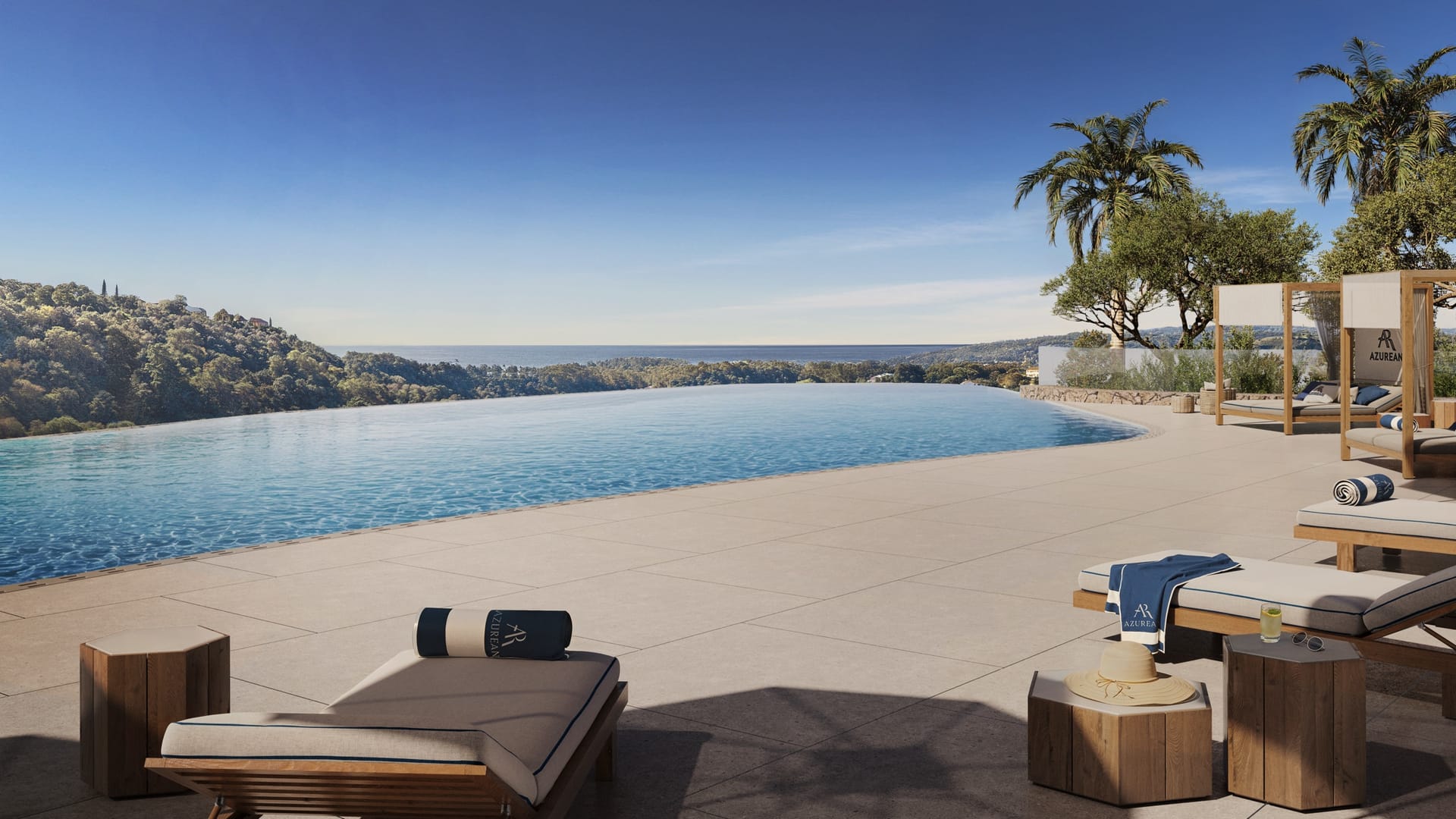 The infinity pool, with loungers along its edge and the coast beyond. Azurean Marbella, La Reserva de Alcuzcuz, Benahavís.