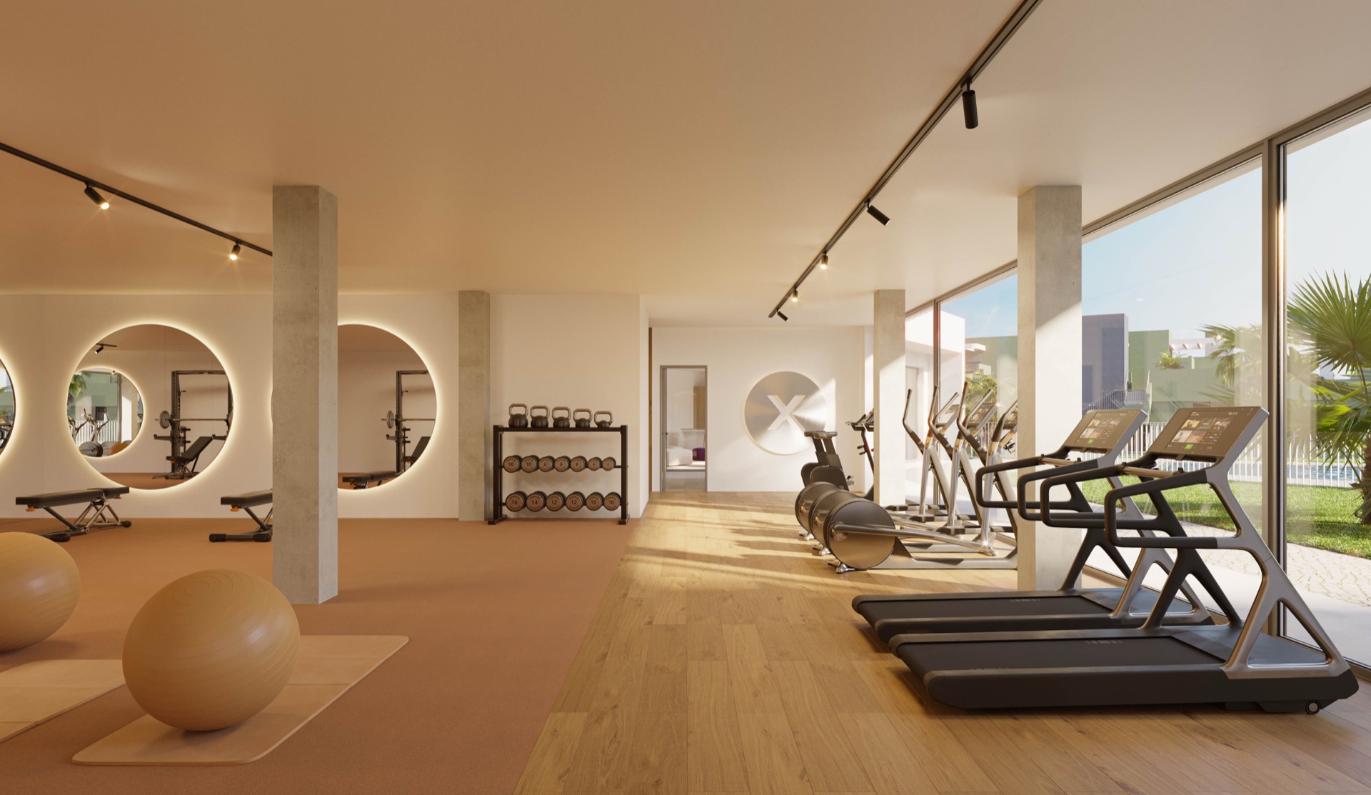 The gym, with running machines along a glass wall and round mirrors opposite. Bahía, La Cala de Mijas, Mijas.