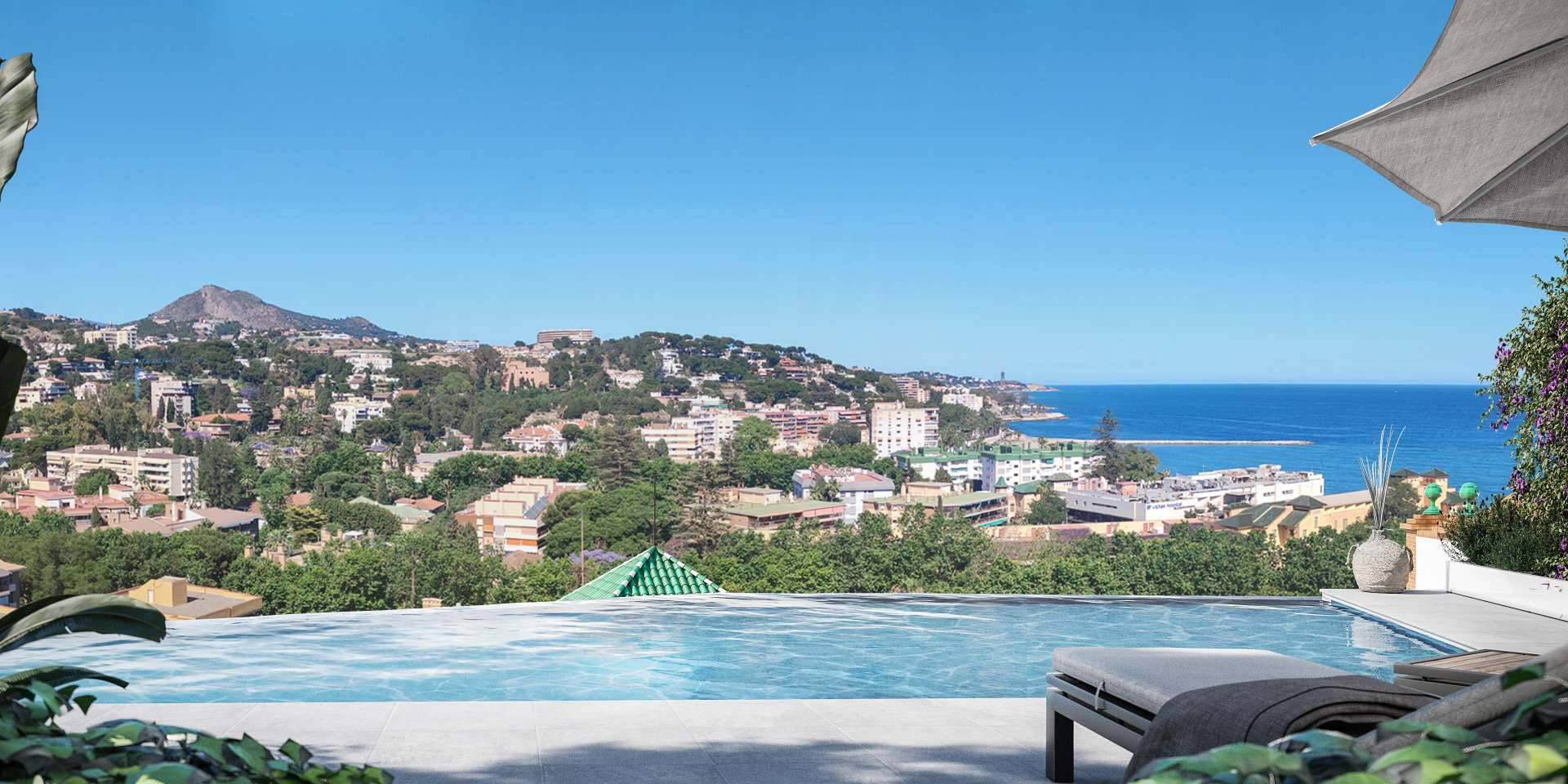 A pool on a high terrace with a sun lounger at its edge, looking out over the rooftops and hills of Málaga to the sea. Be Grand El Limonar, El Limonar, Málaga.