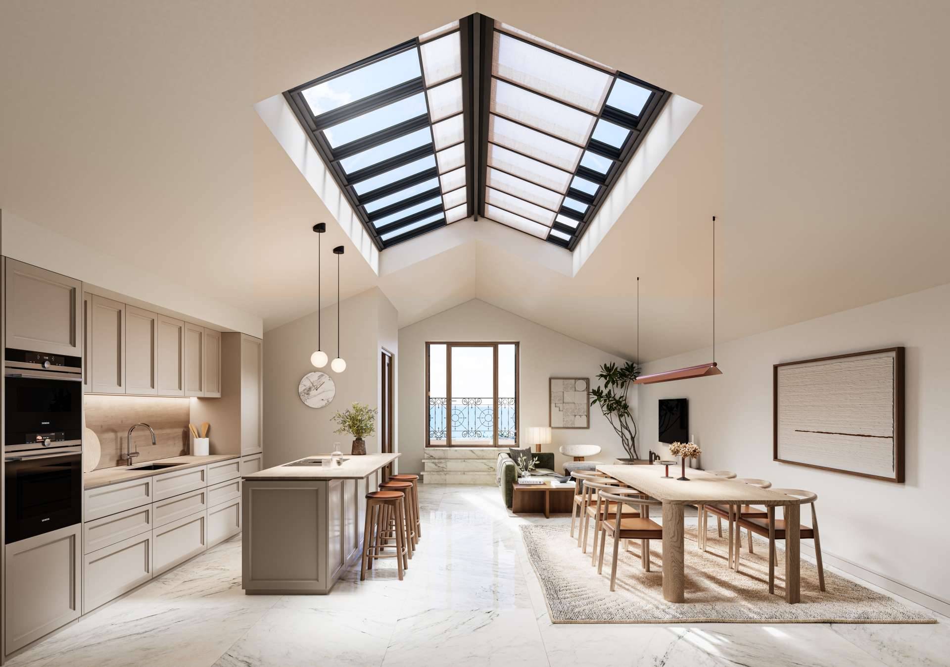 An open kitchen with an island and a long dining table on a white marble floor, under a pitched ceiling with a large skylight. Be Grand El Limonar, El Limonar, Málaga.