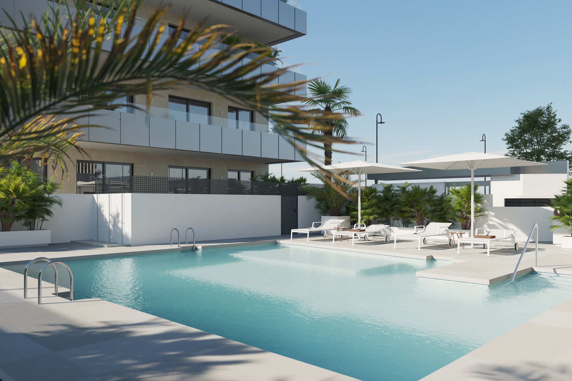 The outdoor pool in the shared grounds, with one of the buildings standing behind it. Biznaga, Las Lagunas, Mijas.