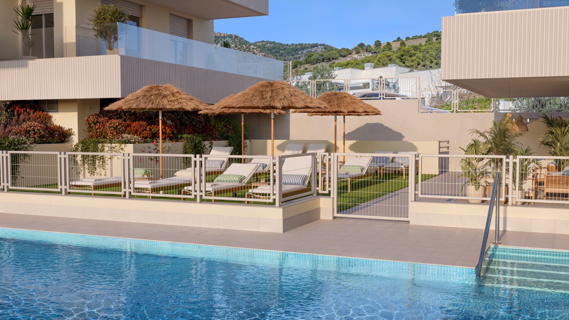 Sun loungers under thatched umbrellas along the pool terrace. Blossom Hills, Benalmádena Pueblo, Benalmádena.