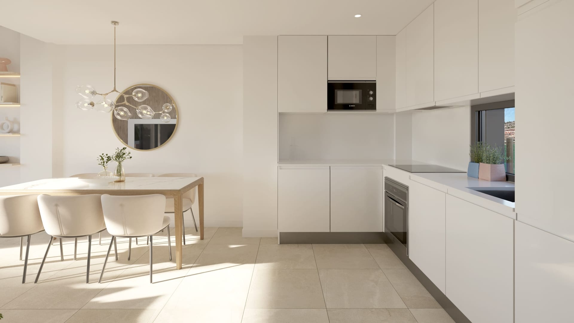 The kitchen and dining area, with white units, a white worktop and the oven and microwave built in. Blue Wave, La Chullera, Manilva.