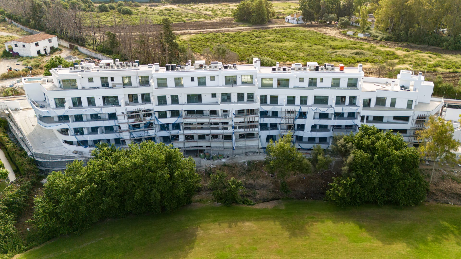The front of the buildings and the lawn below them, seen from the air. Breeze, Guadalmina Alta, Marbella.