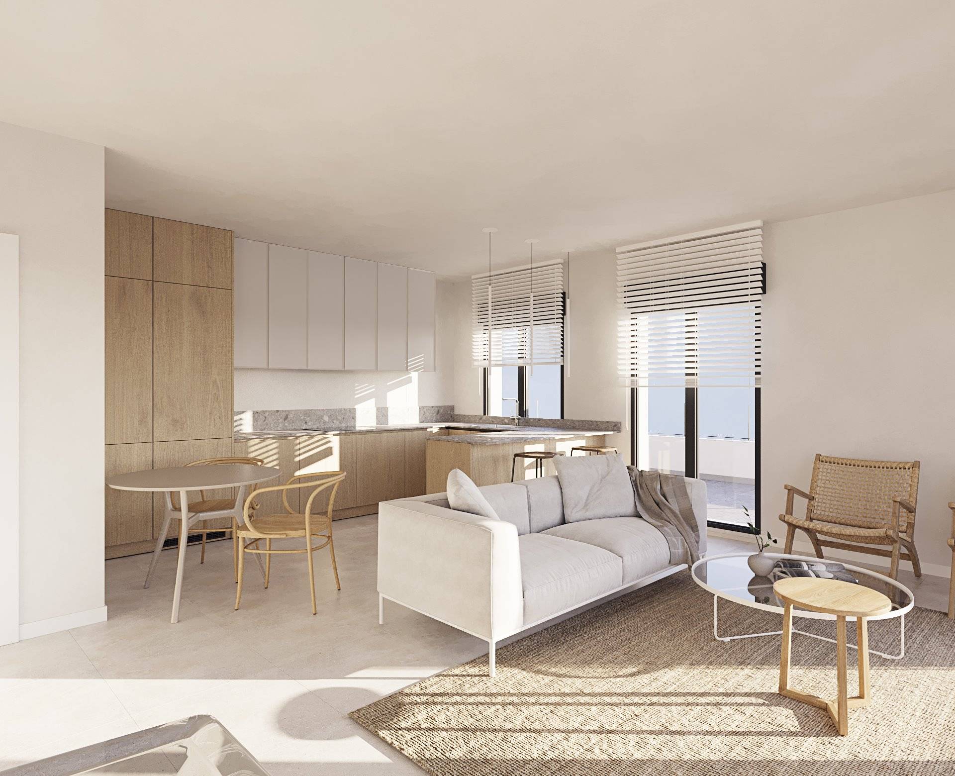 The living room and kitchen in one open space, with white and light wood units, a grey worktop and a round dining table. Casares Bay, Doña Julia, Casares.