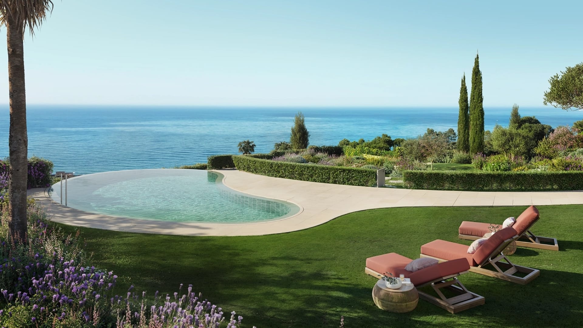 The outdoor pool on its lawn, with the sea beyond. Casatalaya Residences, Torremuelle, Benalmádena.