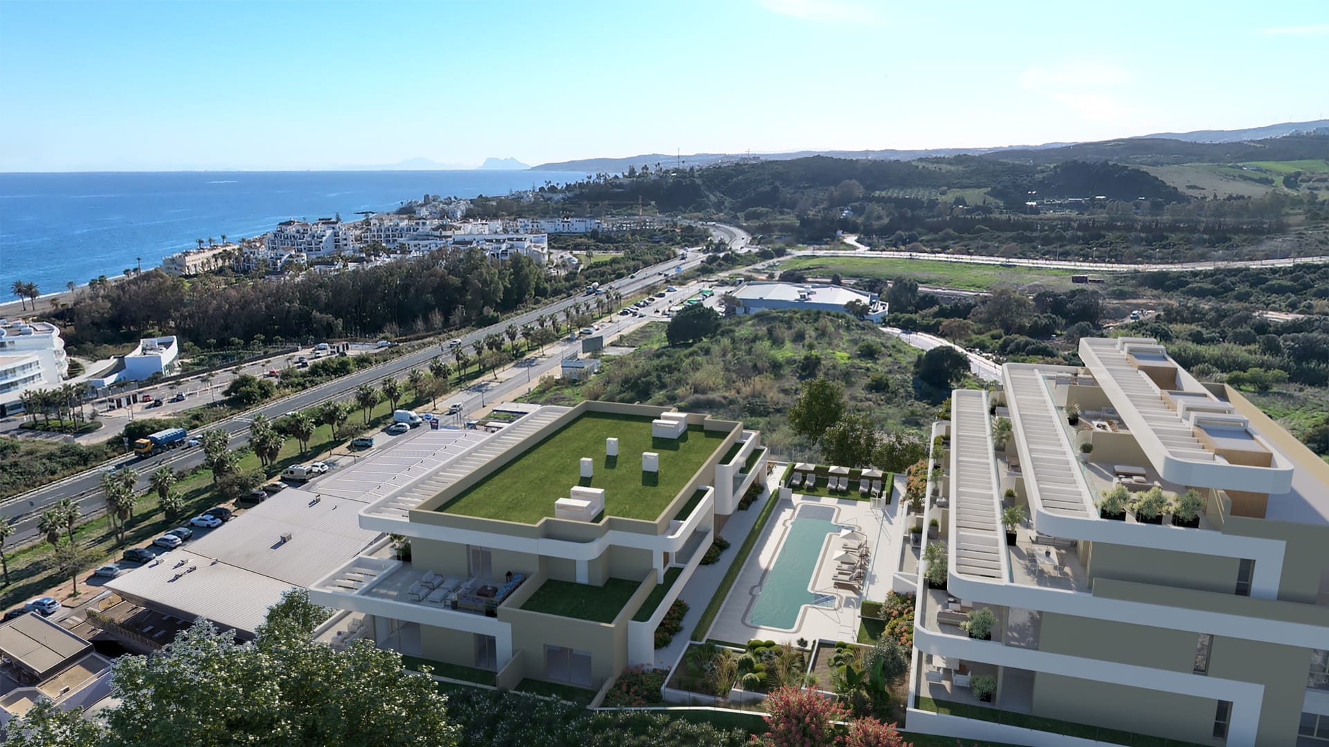 An aerial view of the buildings, their gardens and pool, with the sea to the left. Celestia Homes, Arroyo Enmedio, Estepona.