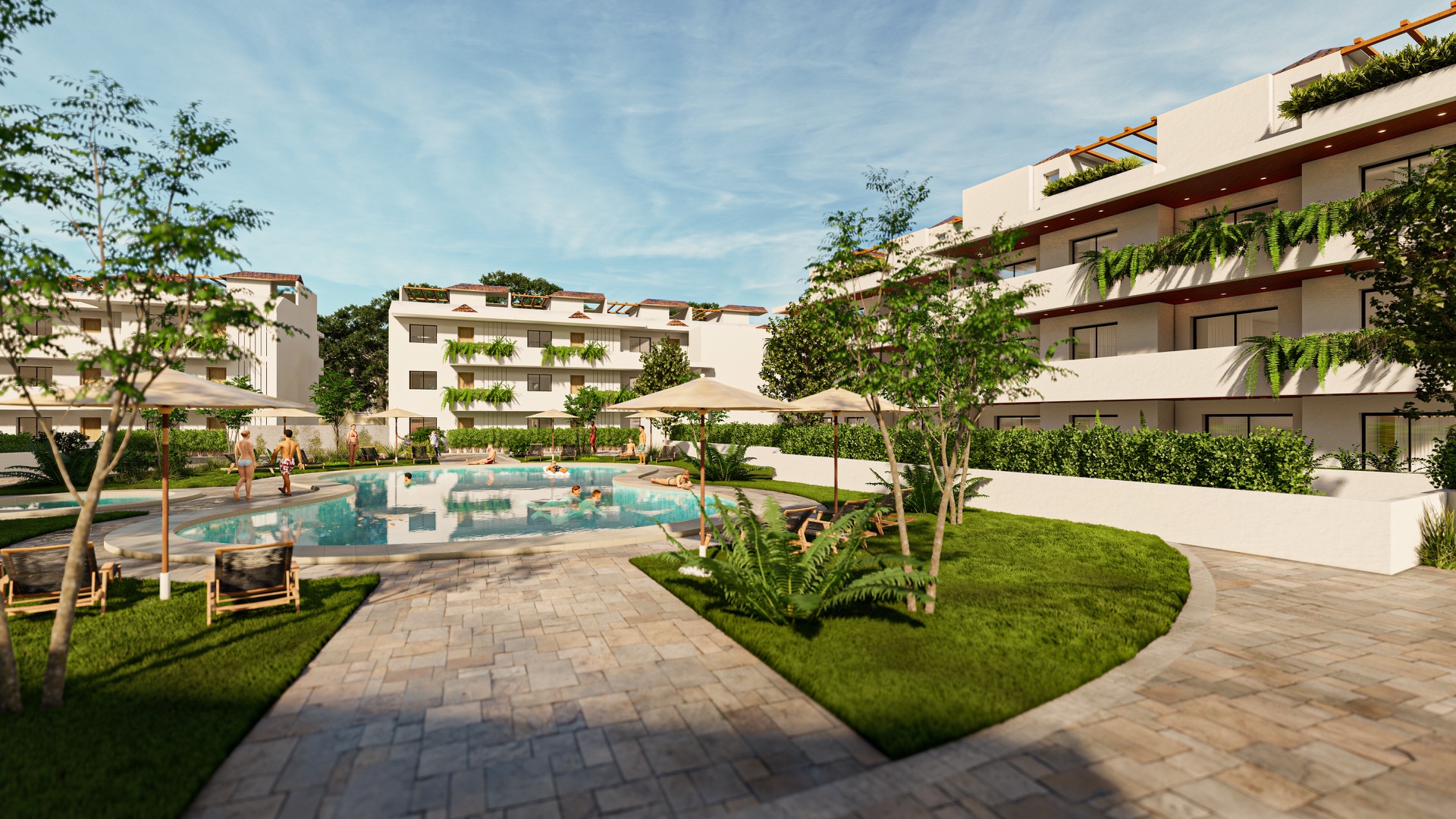 The pool and the garden between the buildings, with loungers and parasols on the lawn. Coral Mijas Residencial, Riviera del Sol, Mijas.