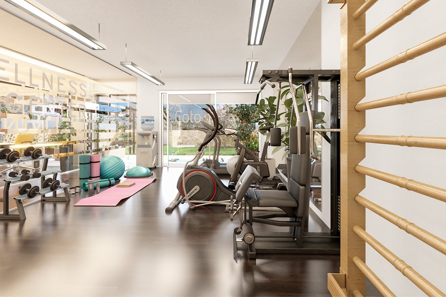 The gym in the wellness centre, with free weights, machines and wall bars, and glazing onto the planting outside. Coto Homes, El Coto, Mijas.