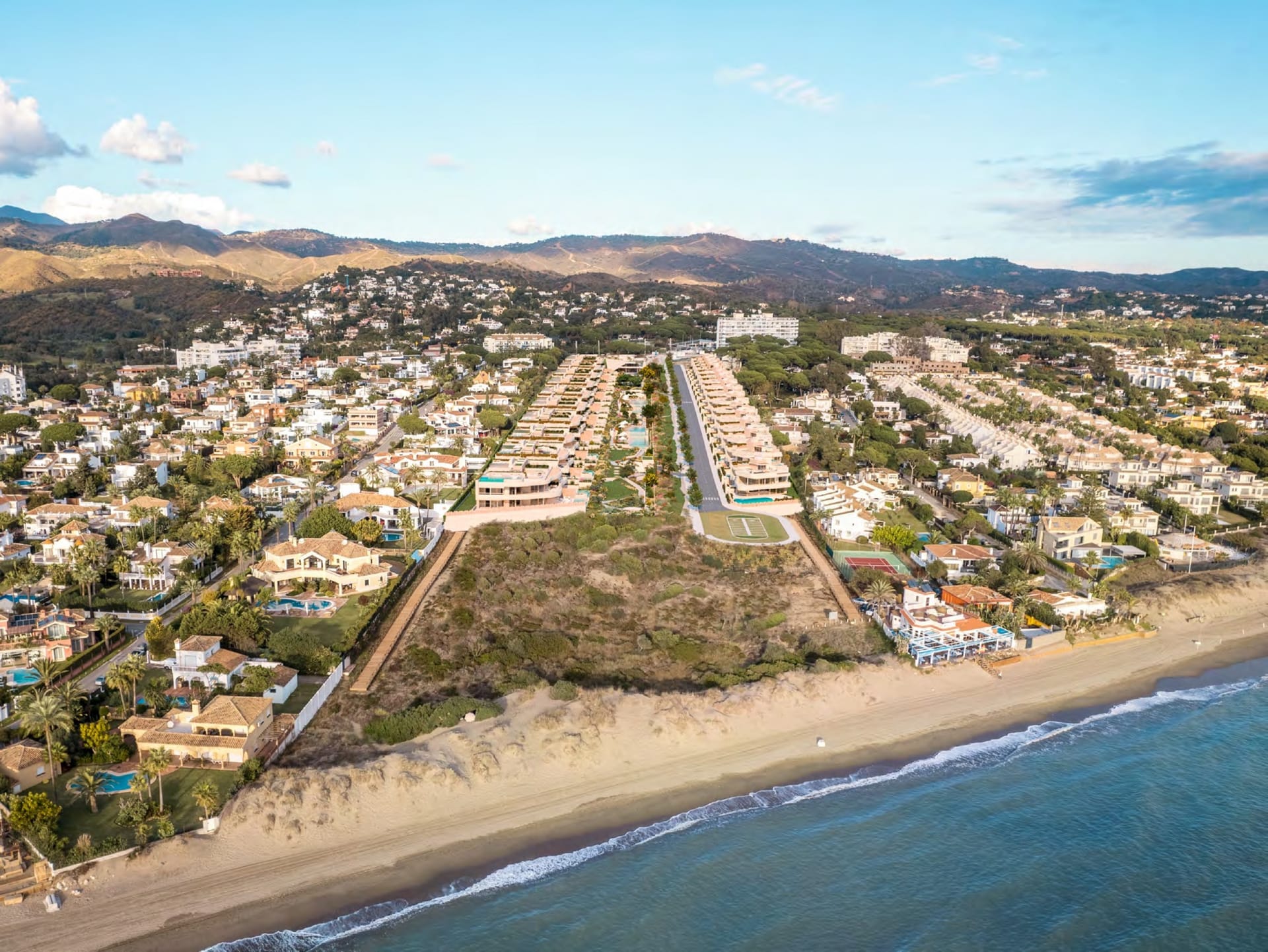 An aerial view of the plot running down to the beach, with Las Chapas and the hills behind. Dunique Marbella, Las Chapas, Marbella.