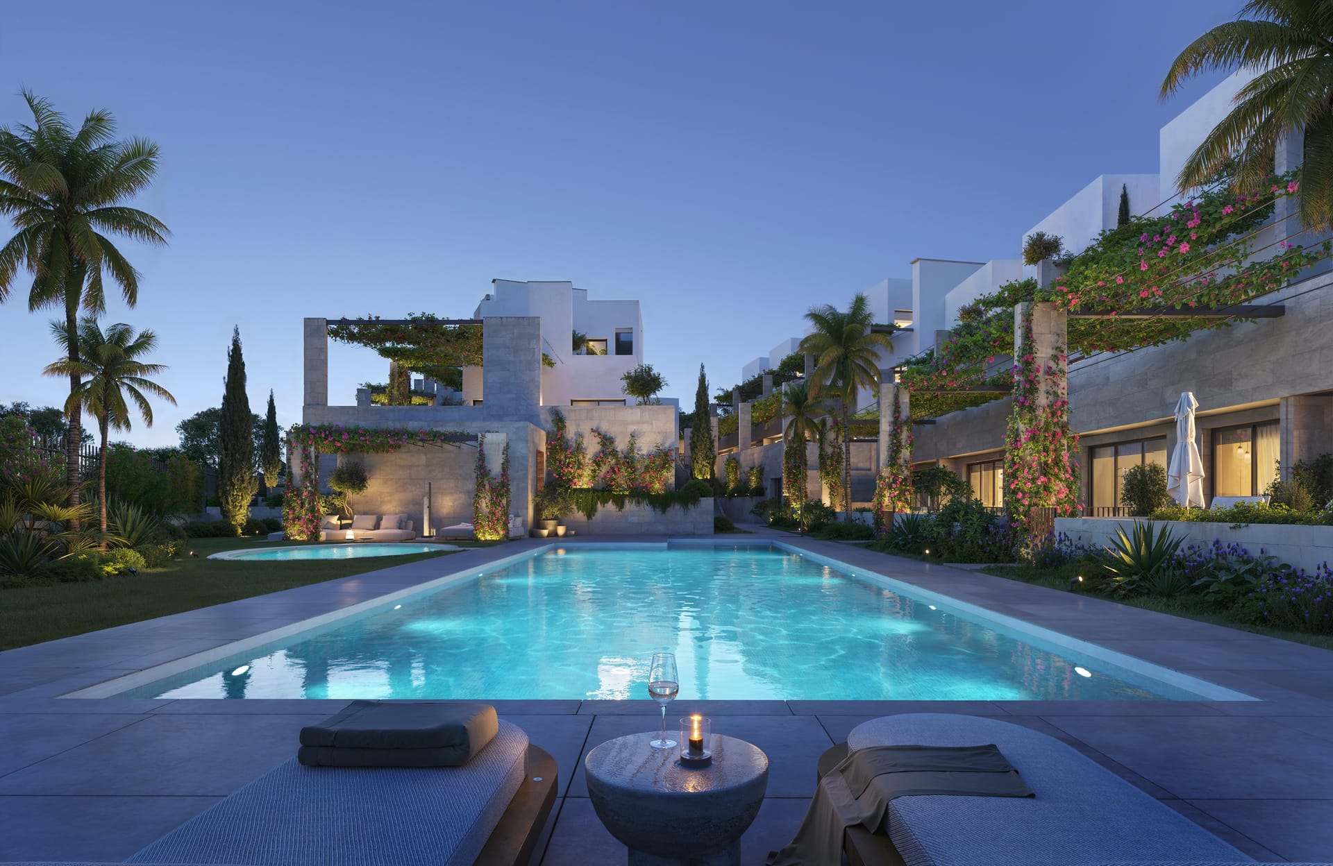 The courtyard pool at night, with the homes lit up behind it. ERA Residence, New Golden Mile, Estepona.