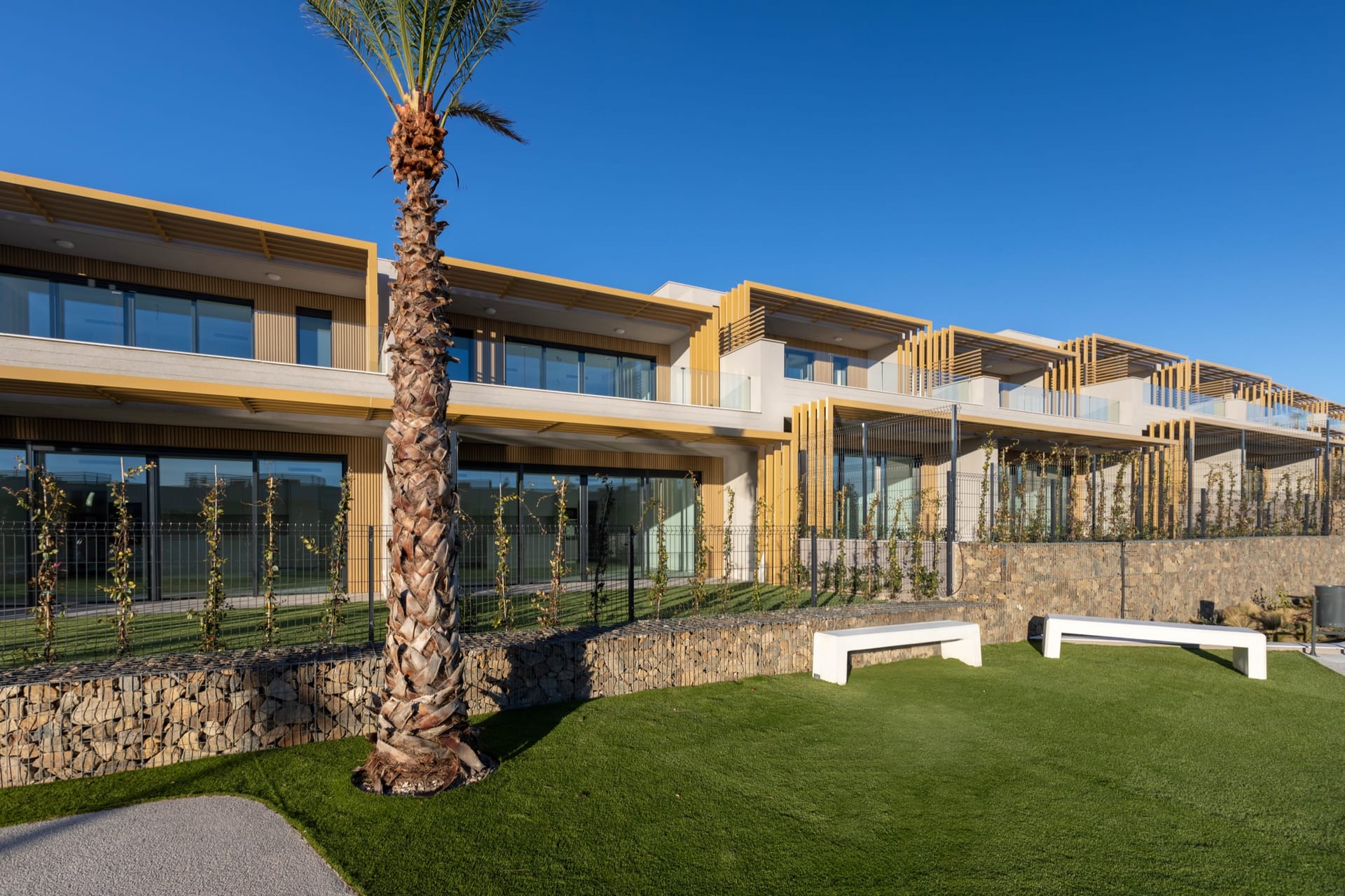 The houses along a communal lawn. Evergreen Homes, El Chaparral, Mijas.