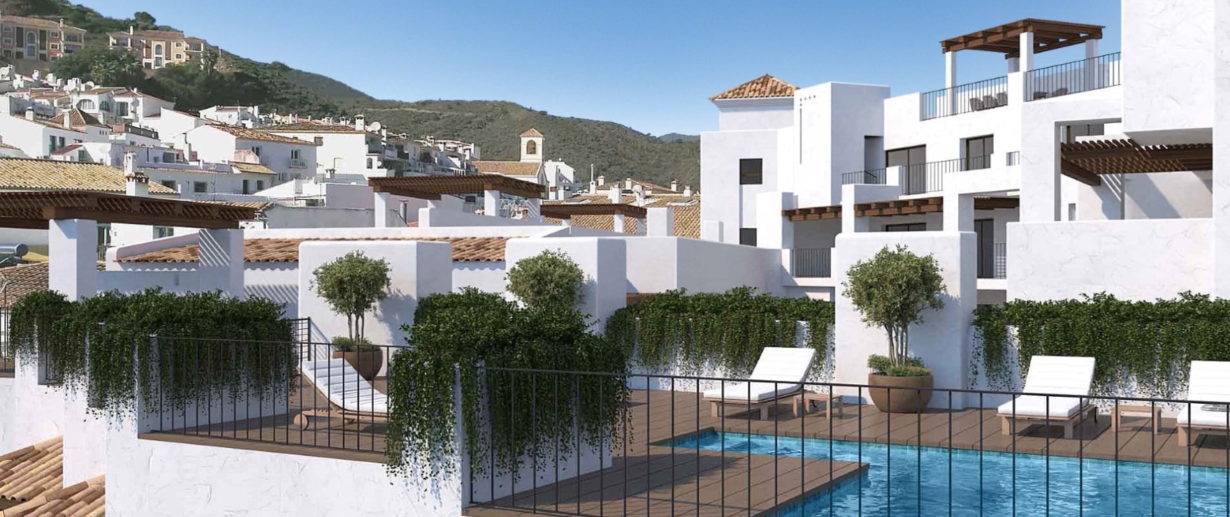 The pool on the roof, with loungers along its edge, planters of olive trees, and the upper floors of the building and the village behind. Fuente Lirios, Calle Fuente de Lirios, Benahavís.