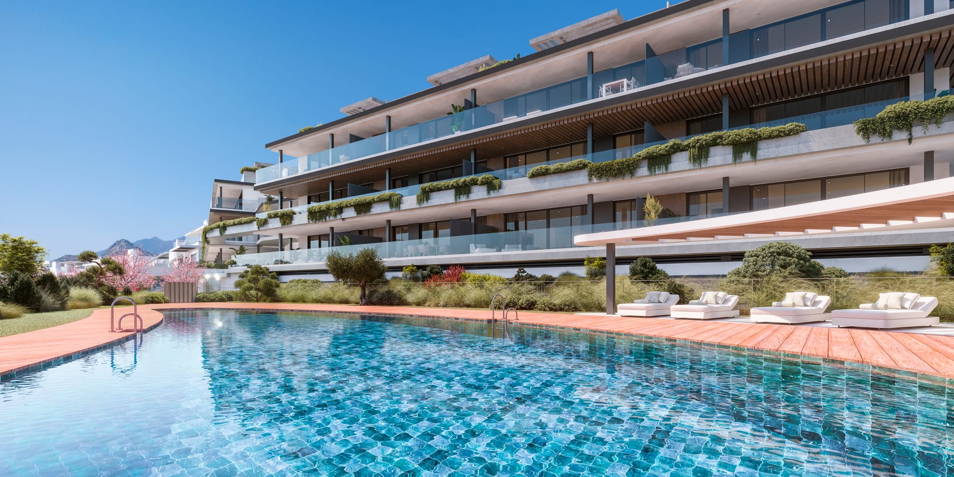 The shared pool, with sun loungers under a curved pergola and an apartment building behind it. Haiku, Cancelada, Estepona.