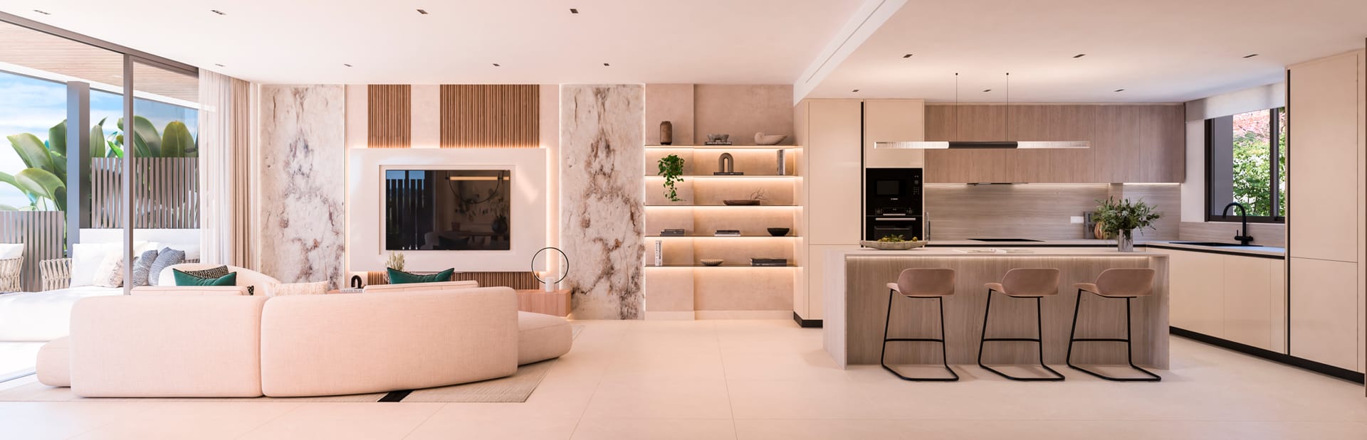 The kitchen and living room of a townhouse, with a long island and three stools on the right and glass doors to the terrace on the far left. Haiku, Cancelada, Estepona.
