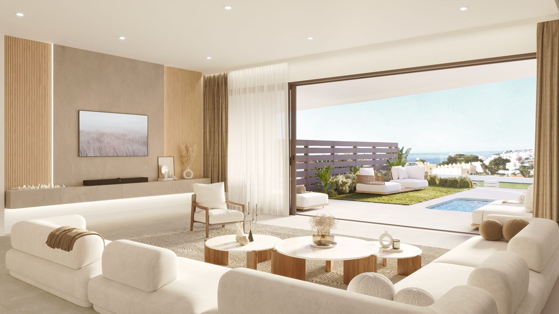 The living room, opening through a wide glass door onto the terrace and the garden. Korall Residences, El Higuerón, Fuengirola.