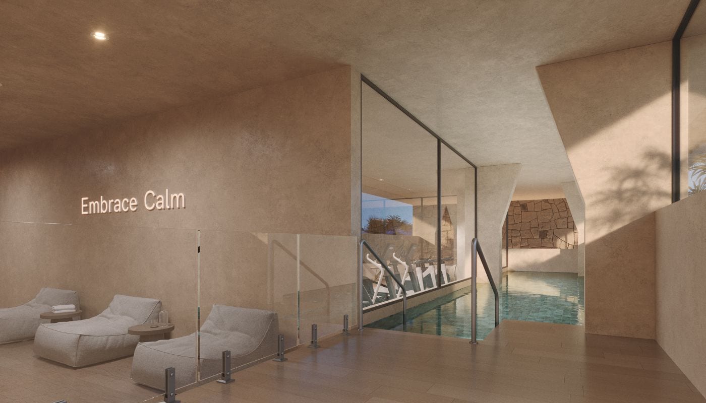 The spa, with loungers beside the heated indoor pool and the gym visible through the glass. Kosmos, El Pinillo, Torremolinos.