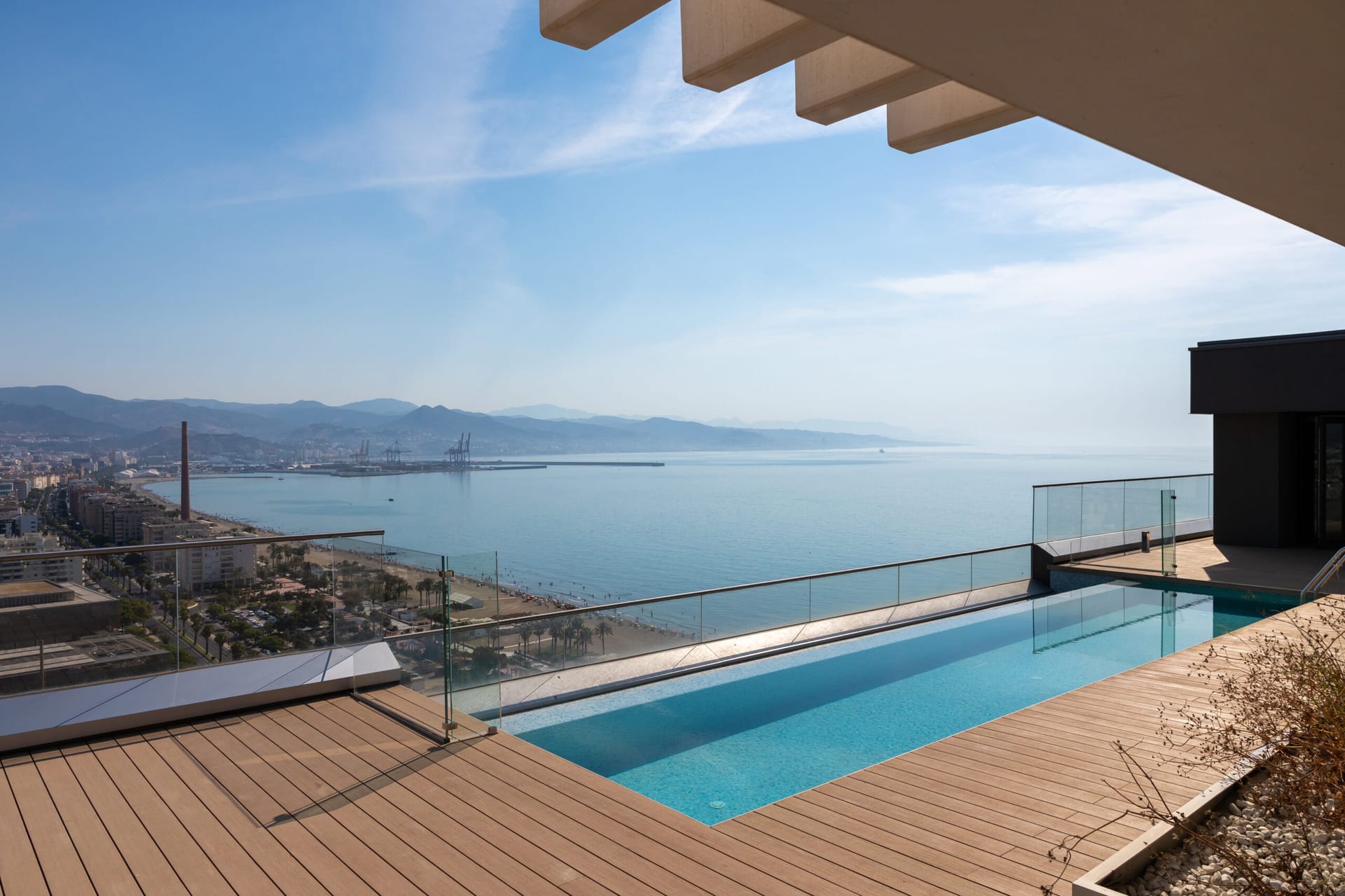 The private infinity pool on the roof of a penthouse, looking along the coast towards the port. Málaga Towers, Carretera de Cádiz, Málaga.