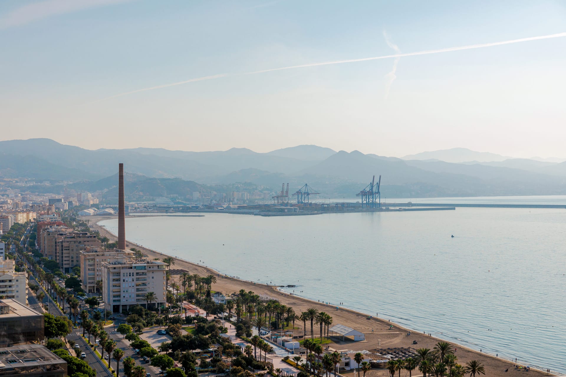 The beach and the port of Málaga from the top of the towers, with the mountains behind. Málaga Towers, Carretera de Cádiz, Málaga.
