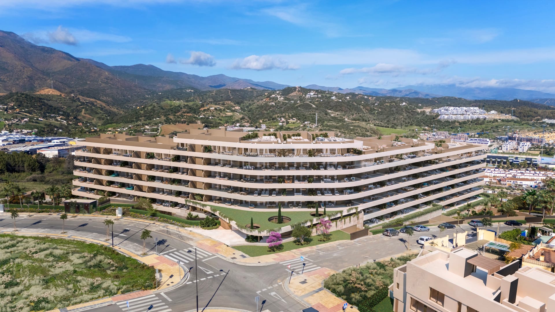 An aerial view of the buildings, with the hills behind them. Maralto, Las Mesas, Estepona.