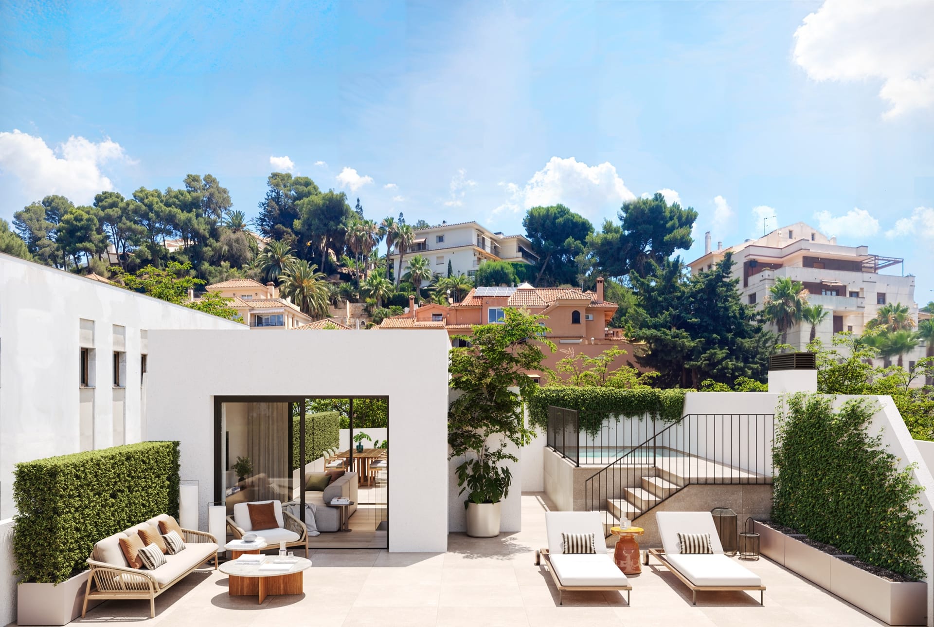 A roof terrace with a white glazed room, sun loungers and a sofa, and steps up to the pool, with pines and villas behind. Miramar 34, El Limonar, Málaga.