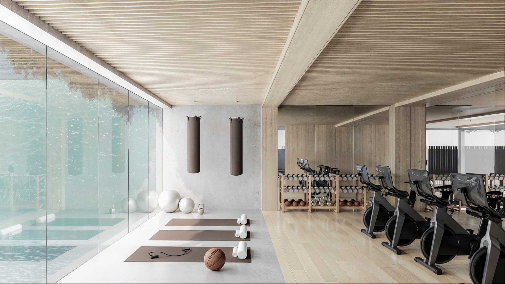 The gym, with exercise bikes and weights beside a wall of glass. Moon 64, Los Hidalgos, Manilva.