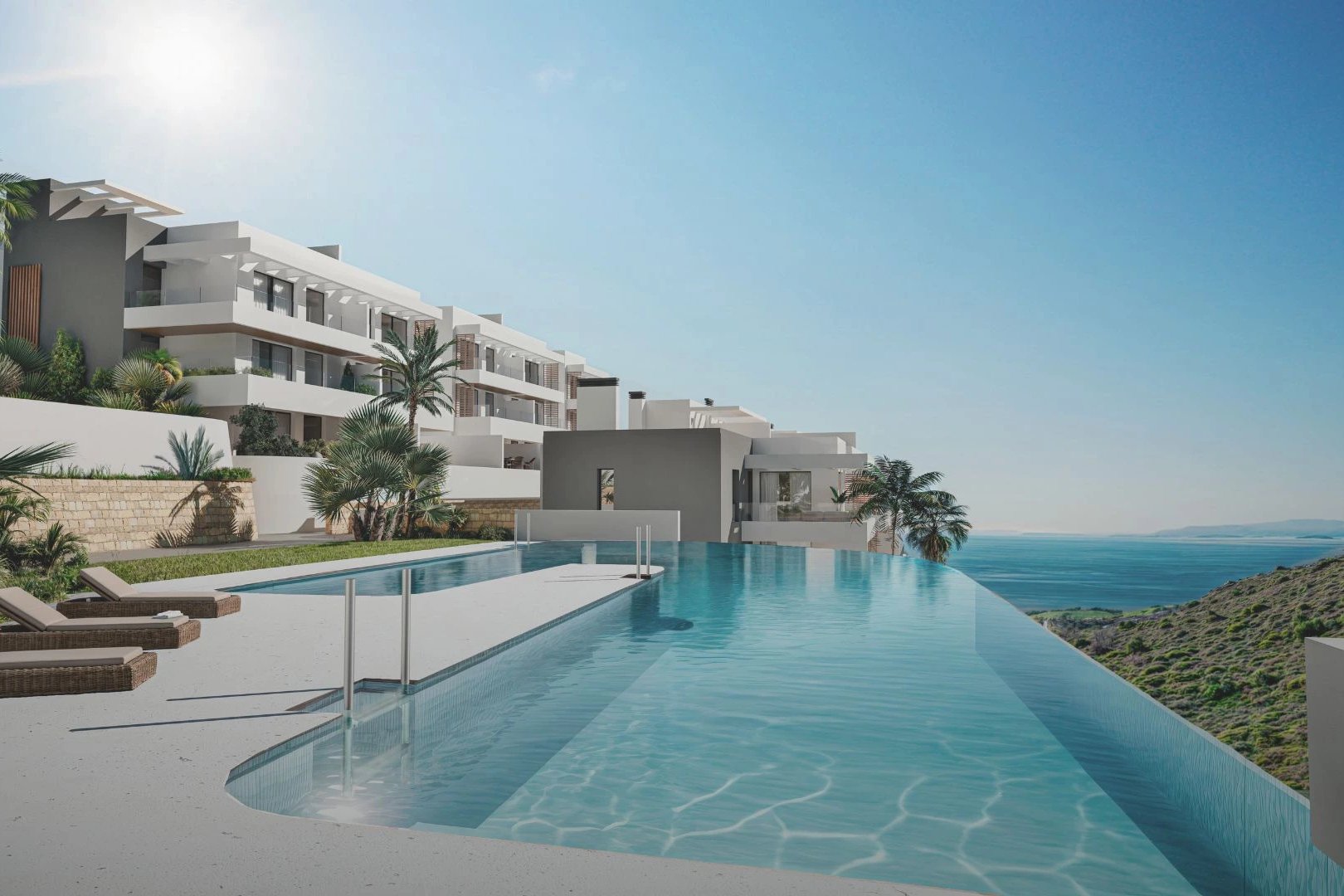 The pool on its terrace, with the hillside dropping away to the sea beyond it. Nylva Homes, La Paloma, Manilva.