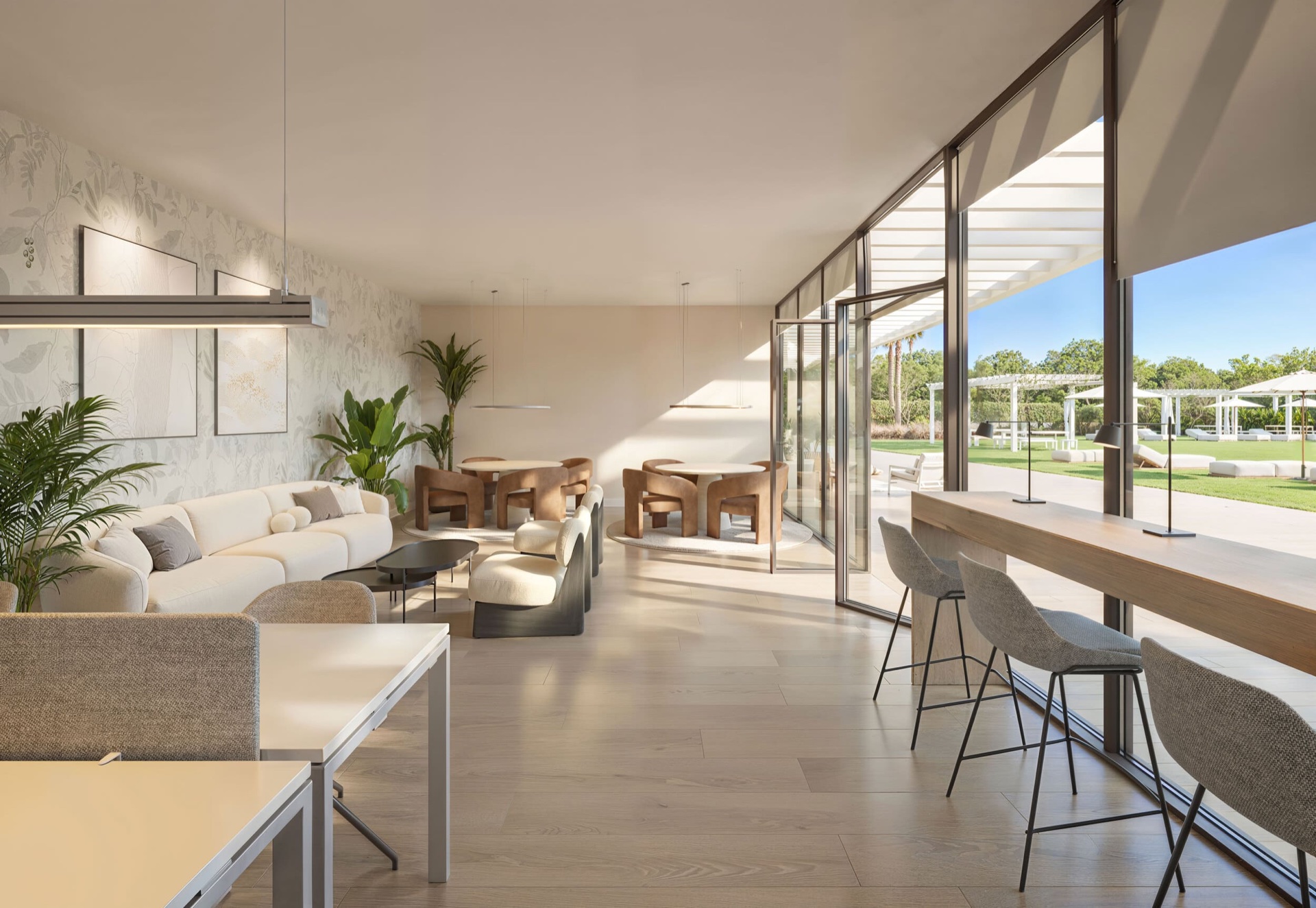 The coworking room, with a long counter at the window and a seating area beside it, opening onto the garden. Ocean Garden, Los Pacos, Fuengirola.