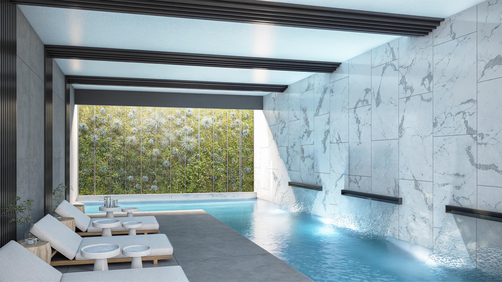 The heated indoor pool in the spa, with loungers beside it and a planted wall beyond. Palm Residences, La Resina, Estepona.