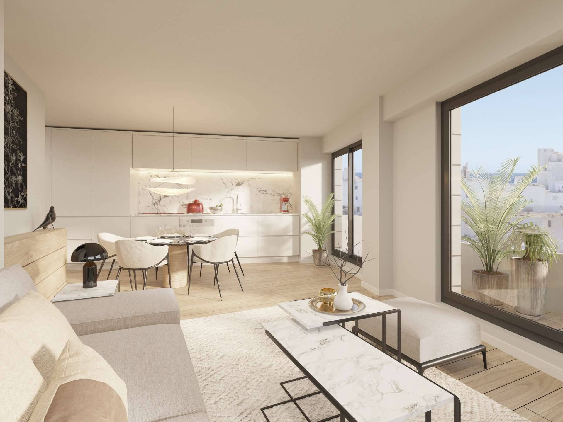 The living room and kitchen in one space, with white handle-less units along the back wall, a marble-effect splashback and a round dining table. Portamare, Puerto de Estepona, Estepona.