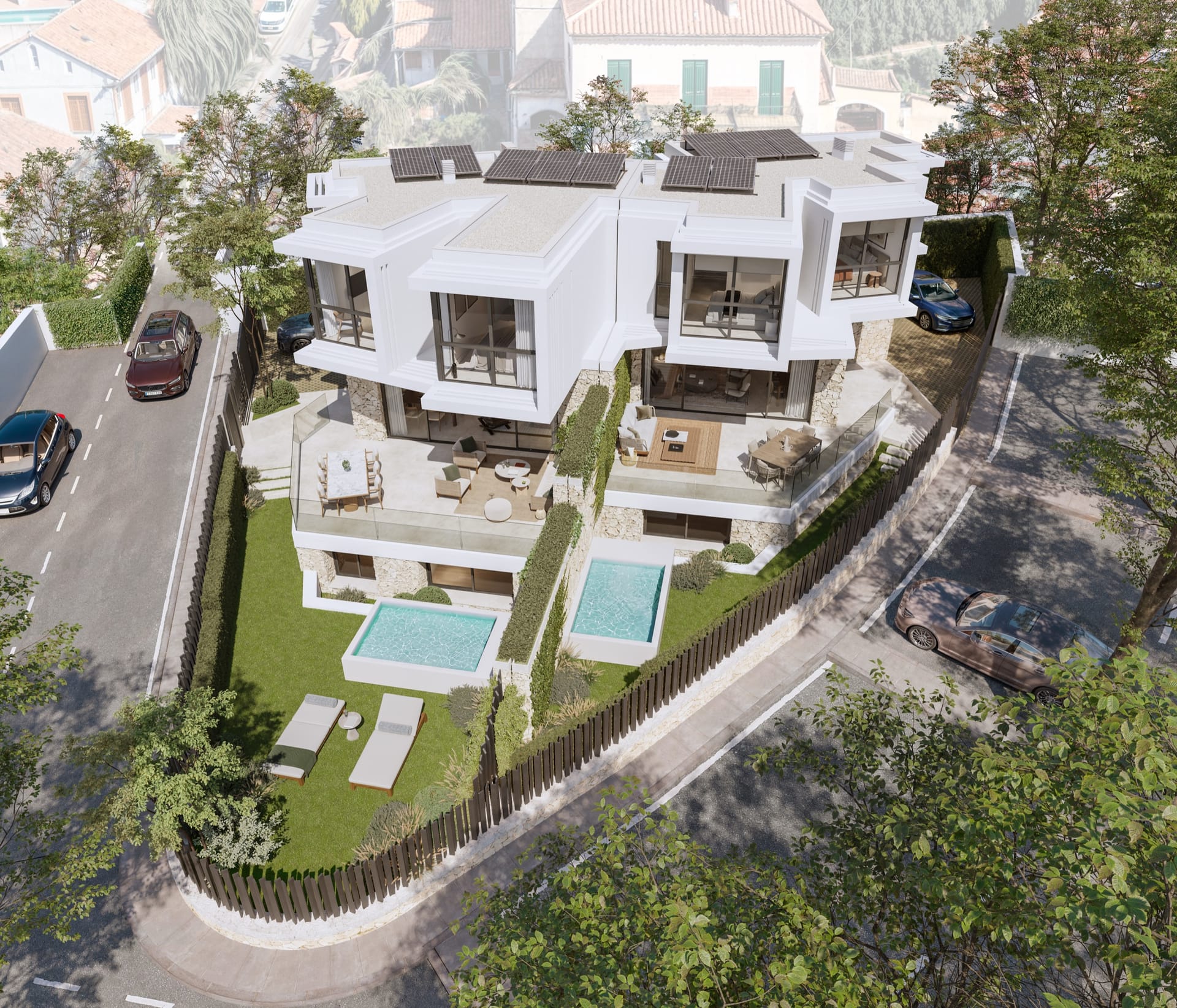 An aerial view of the two houses on their corner plot, each with a lawn and a small pool, with older houses behind. Portugal 2, Pedregalejo, Málaga.