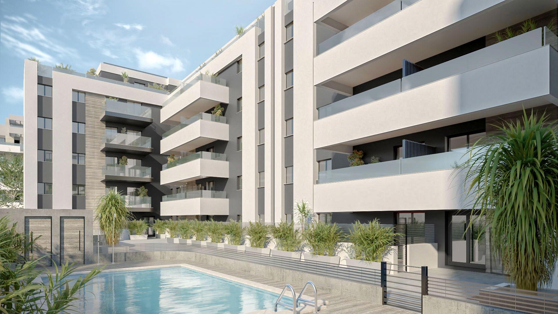 The shared pool beside the buildings, with a planted border along the terraces. Premier Residencial, Las Lagunas, Mijas.