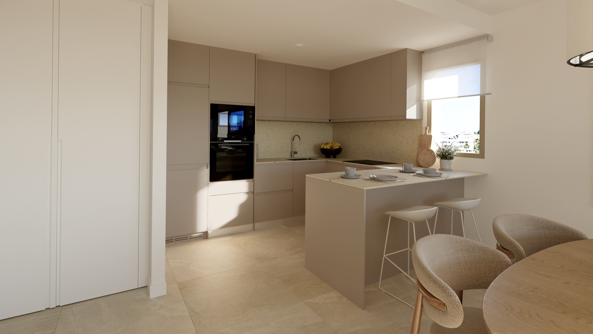 The kitchen, finished in pale units, with the oven and microwave set into a tall unit and a breakfast bar at one end. Riviera Hill, Riviera del Sol, Mijas.