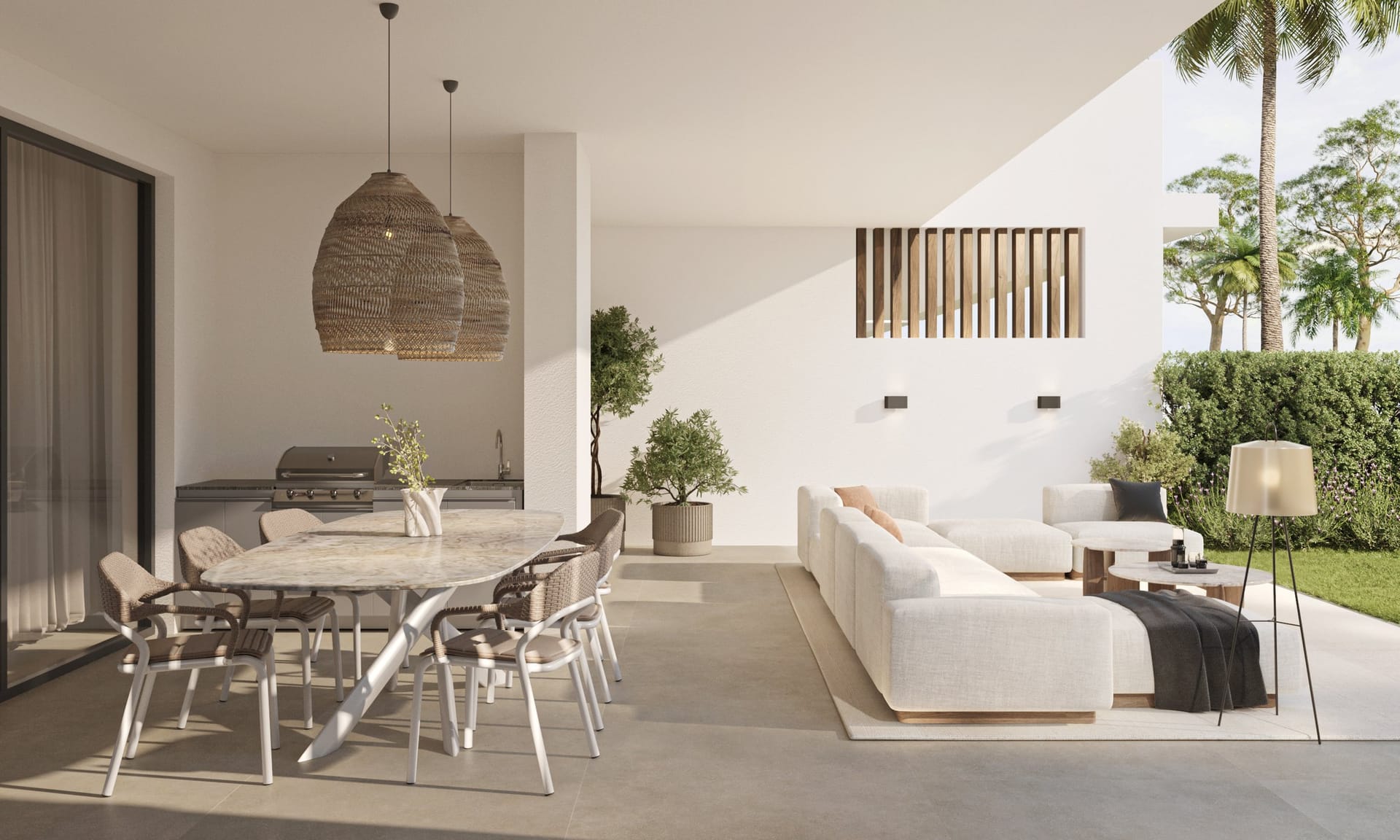The covered terrace of a ground floor home in the developer’s illustrations, with a dining table, a sofa and the garden beyond. Royal Park Residence, New Golden Mile, Estepona.