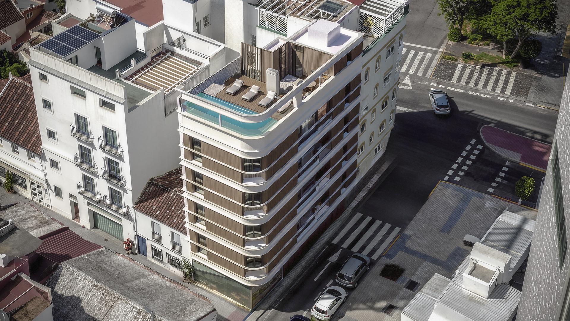 An aerial view of the building on its corner of the avenue, with the roofs of the town centre around it. San Lorenzo 52, Avenida San Lorenzo, Estepona.