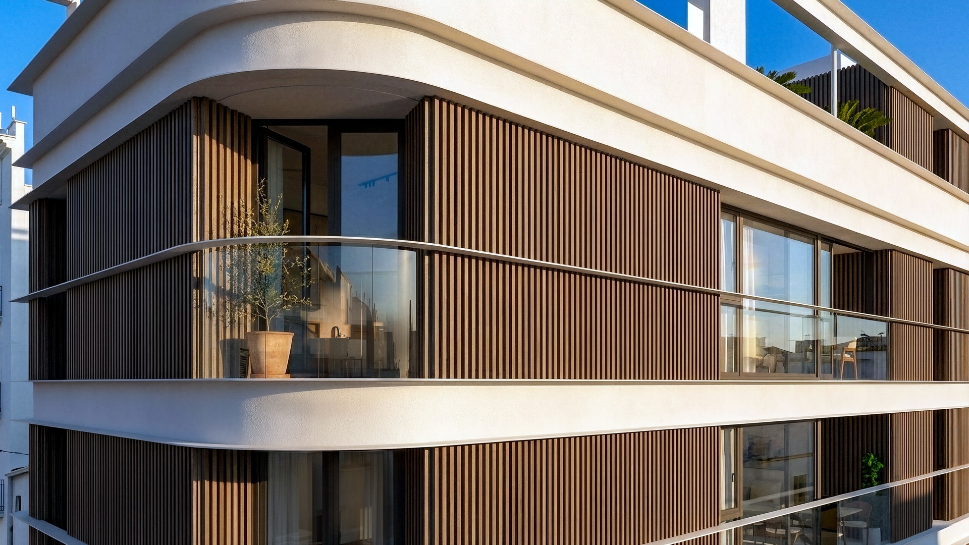 The curved balconies along the front of the building, screened by timber-look slats. San Lorenzo 52, Avenida San Lorenzo, Estepona.
