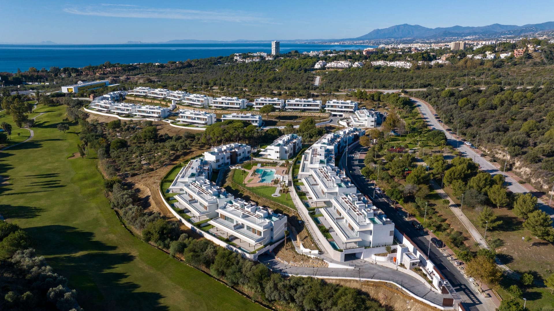 An aerial view of the scheme and the golf course, with Marbella and the sea beyond. Santa Clara Homes, Los Monteros, Marbella.
