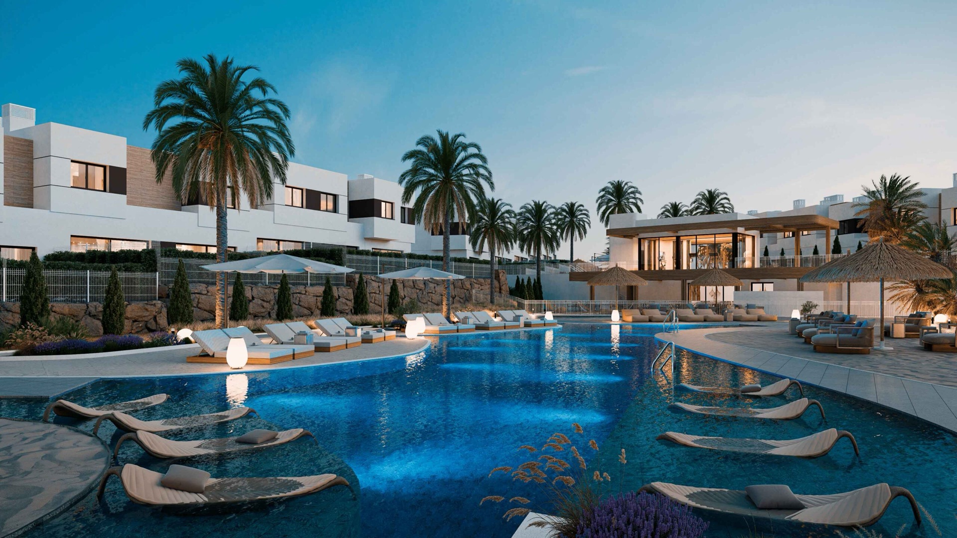 Savia’s pool at dusk, with the loungers lit along its edge. Savia, Hipódromo, Mijas.