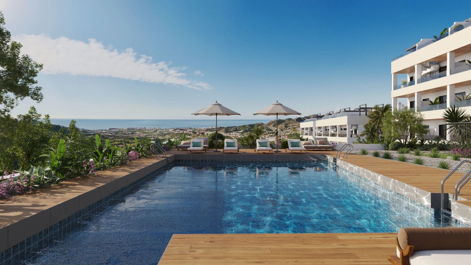 The pool and its deck, with one of the buildings behind it and the sea beyond. Sea Views, Cerro Lago, Torrox.