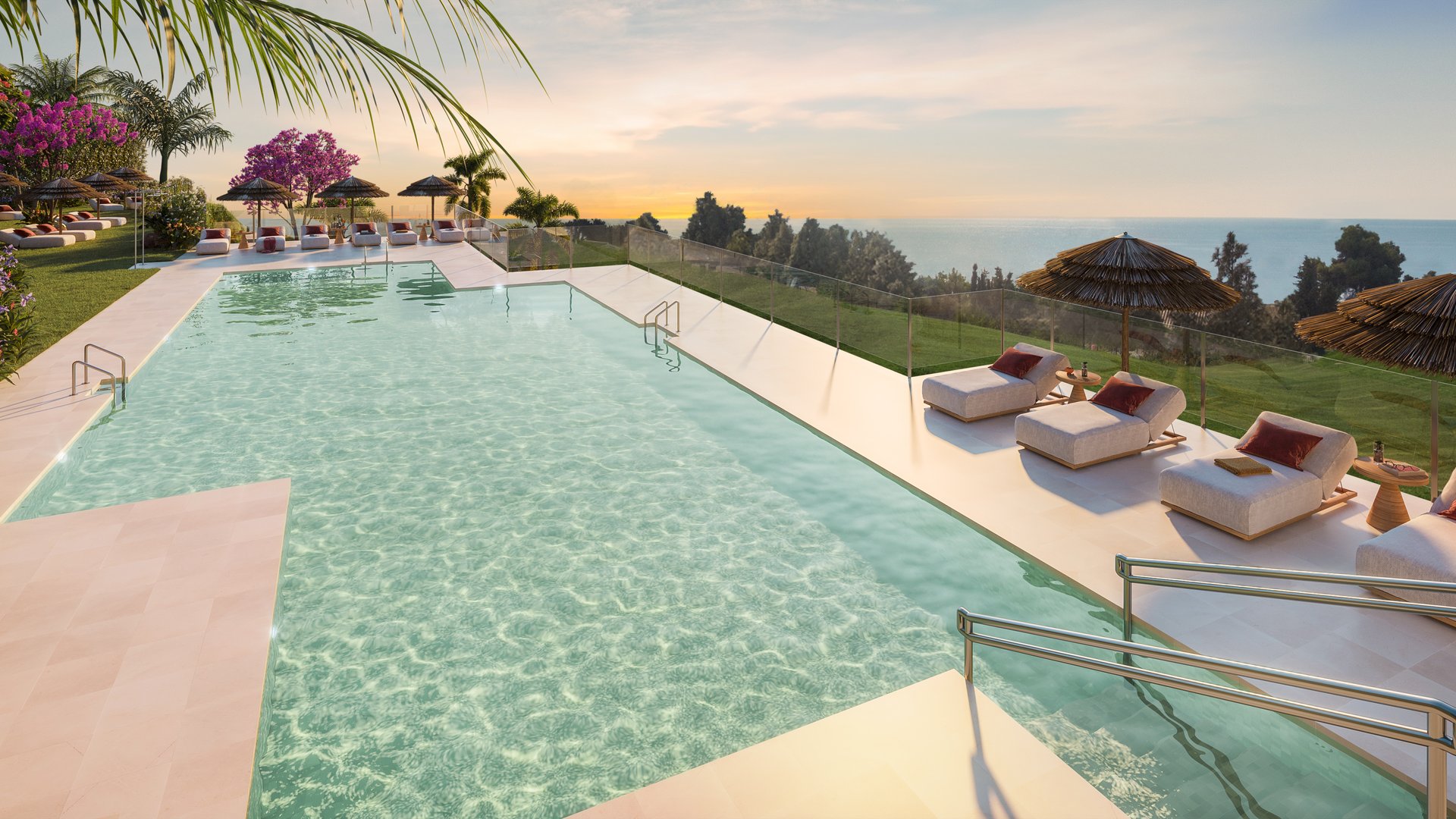 The shared pool by day, sun loungers and parasols along its edge and the planting of the golf course behind. Soleia Living, El Chaparral, Mijas.