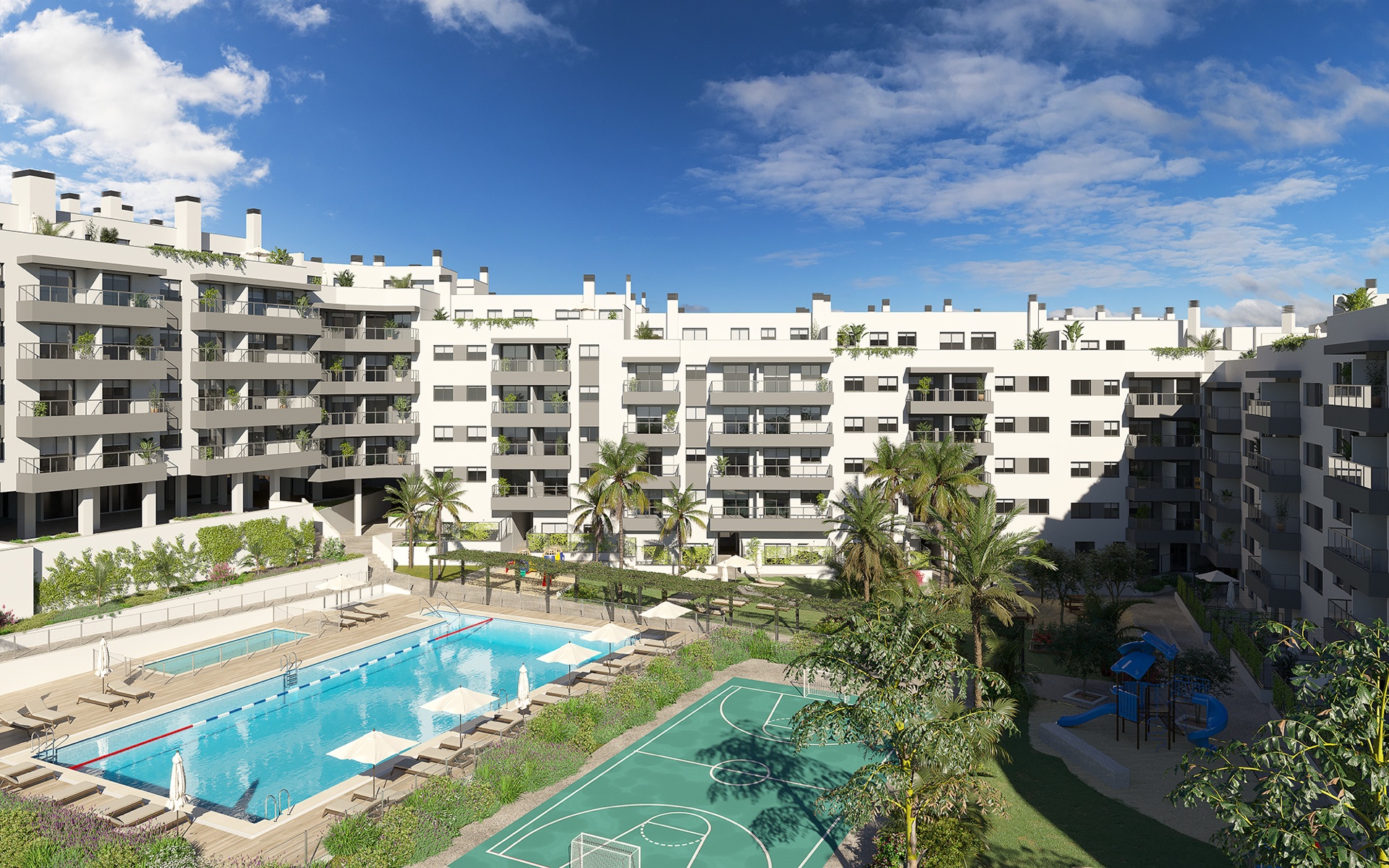 The pools, the sports court and the play area seen together from above. Suite Mijas Phase Three, Las Lagunas de Mijas, Mijas.