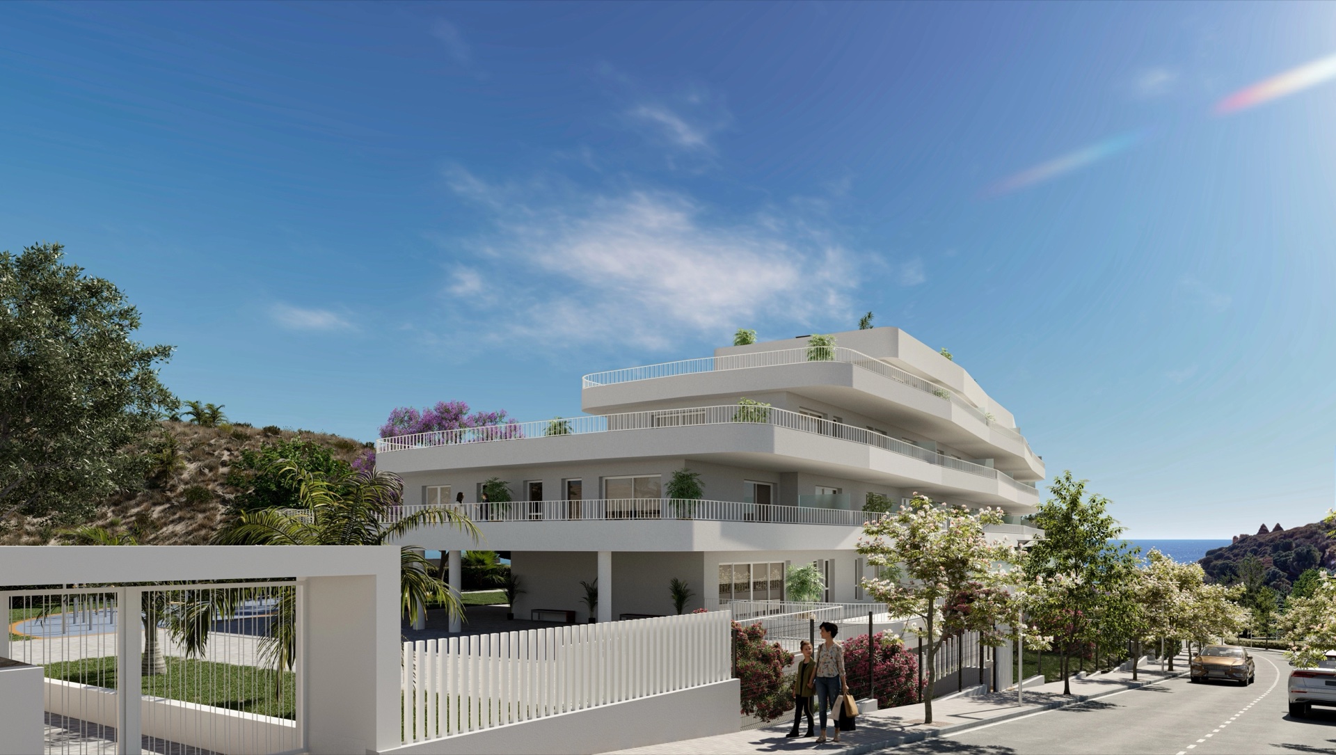The entrance to the grounds from the street, with the building set back behind planting and railings. Sunset Views, Los Pacos, Fuengirola.