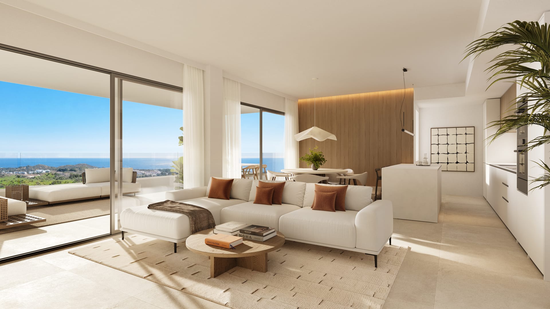 The living and dining room, with the kitchen and its island on the right and sliding glass doors onto a terrace that looks out to the sea. The Eagle Residences, Hipódromo, Mijas.