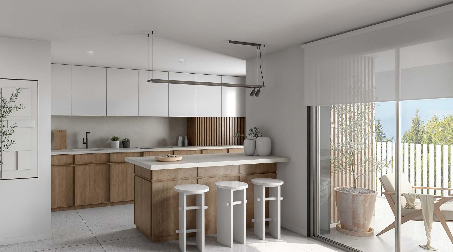 The kitchen, with white wall units, wood-finish base units and an island with three stools beside the sliding doors to the terrace. The Oak 48, El Calvario, Estepona.