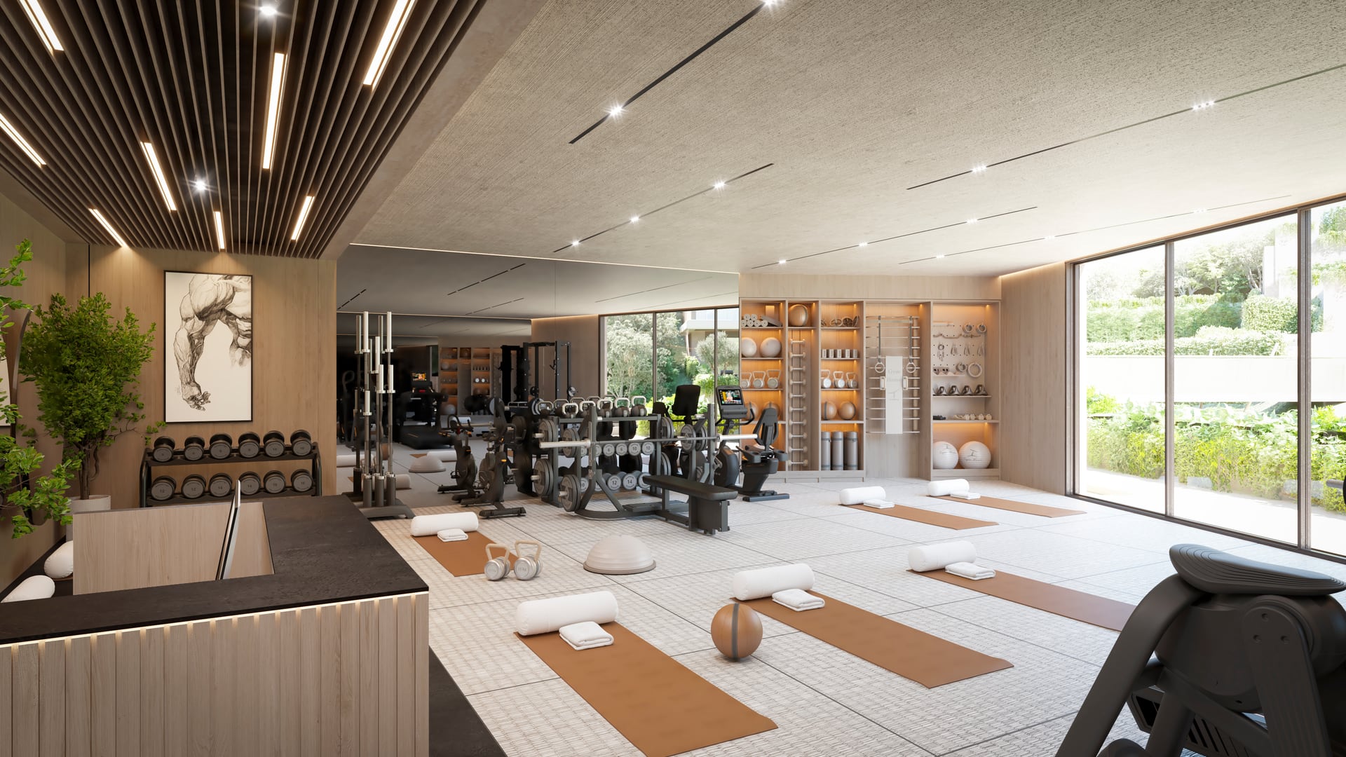 The residents’ gym, with weights and exercise machines, mats laid out for yoga, and a glass wall looking onto the gardens. The Valley, Elviria, Marbella.