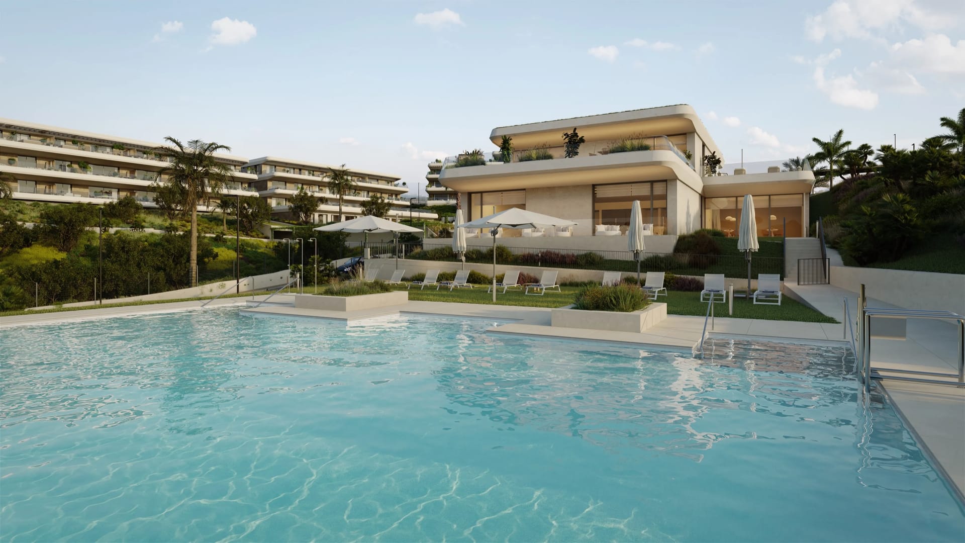 A pool beside a low pavilion, with loungers and white parasols on the lawn. Thera I, La Resina, Estepona.
